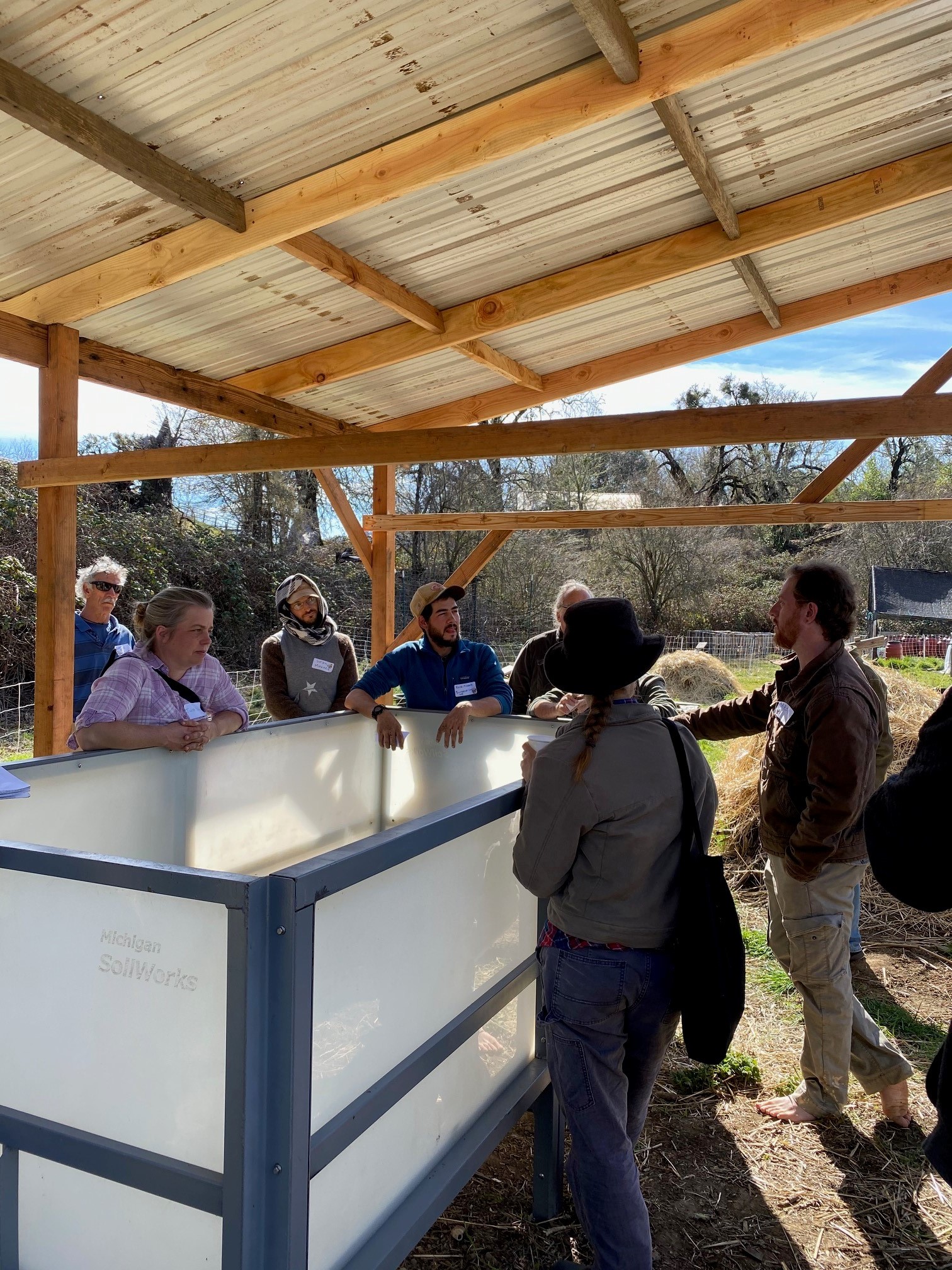 People in a vermiculture workshop having a discussion right next to a Wormgear CFT